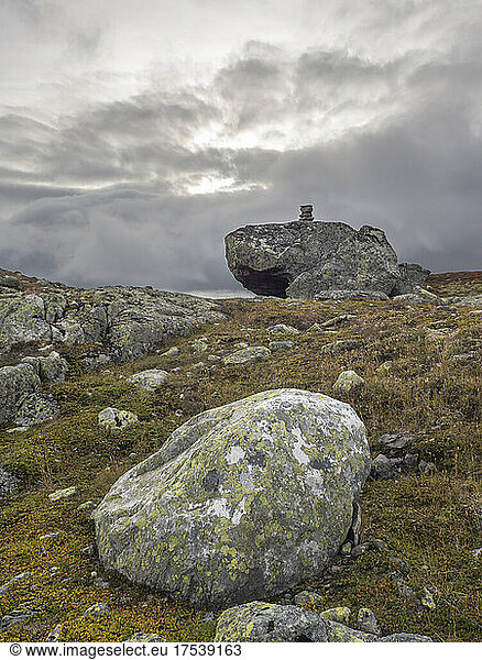 Boulders at Hardangervidda plateau with small cairn in background