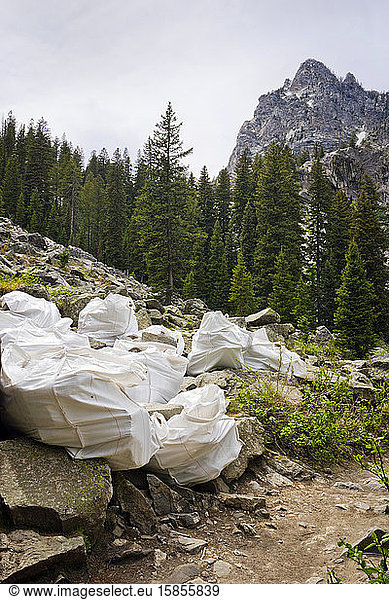 Boulders in bags on the side of a mountain hiking trail