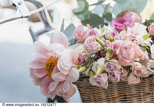 Bouquet of flowers in bicycle basket