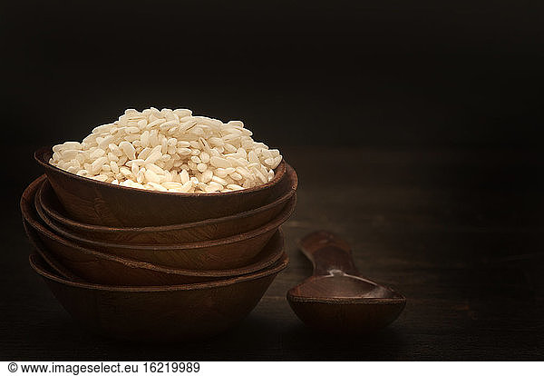 Bowl of basmati rice with wooden spoon  close up
