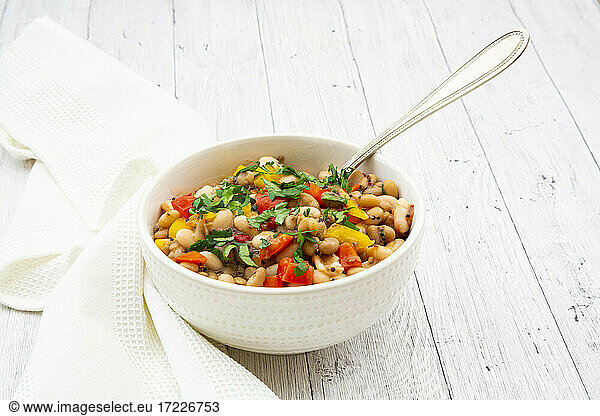 Bowl of bean stew with bell peppers  quinoa and parsley