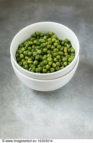 Bowl of blanched peas on metal