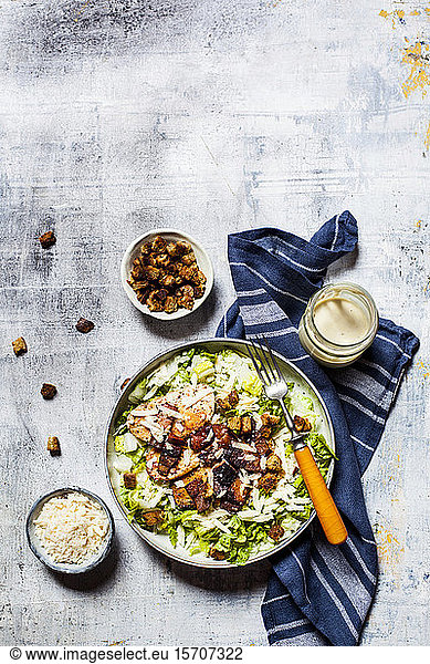 Bowl of Caesar salad with romaine lettuce Parmesan cheese bacon chicken breast and croutons
