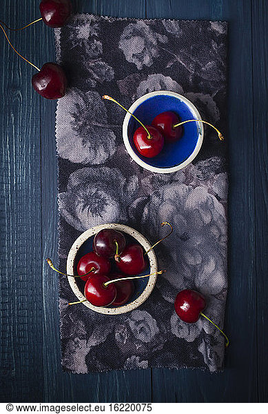 Bowl of cherries on wooden table  close up