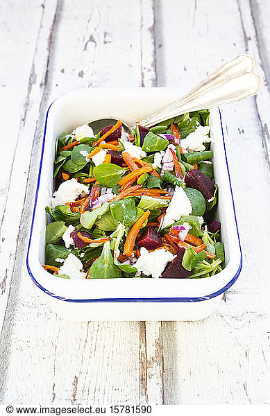 Bowl of corn salad with roasted carrots  beetroots  red onions and goat cream cheese