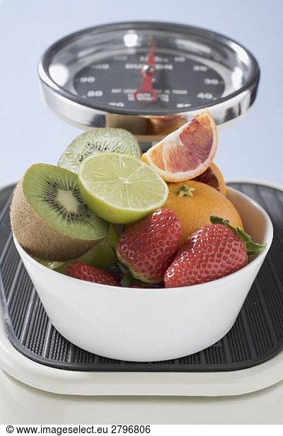 Bowl of fresh fruit on scales