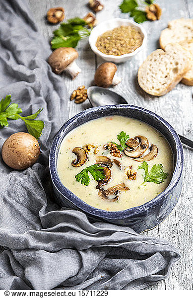 Bowl of German spelt soup with mushrooms  walnuts and parsley
