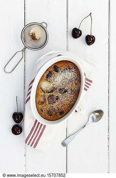 Bowl of gluten free homemade clafoutis with cherries  peaches and almonds
