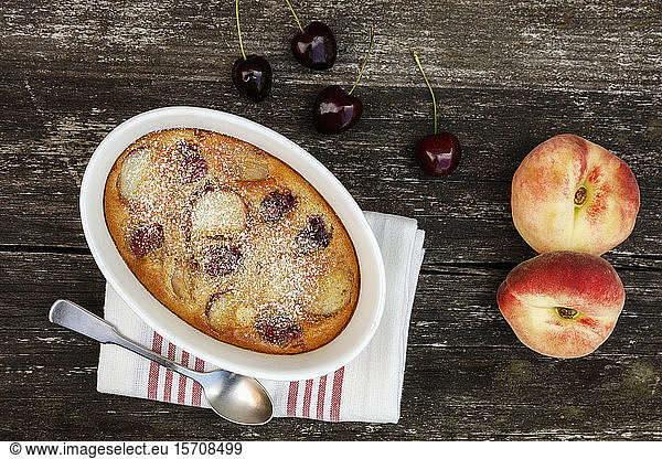 Bowl of gluten free homemade clafoutis with cherries  peaches and almonds