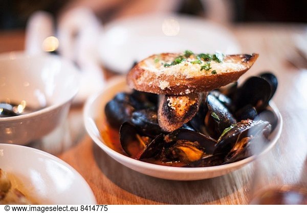 Bowl of mussels with garlic bread