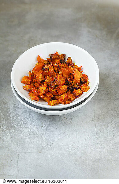 Bowl of roasted chunks of carrots on metal