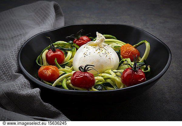 Bowl ofÂ zoodlesÂ with baked tomatoes andÂ burrataÂ cheese