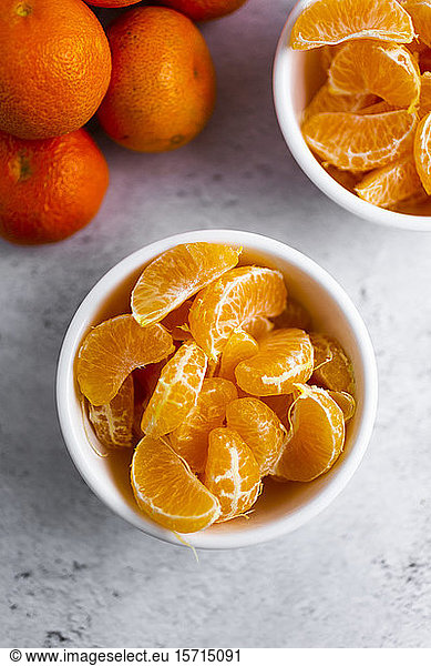 Bowls of freshly peeled mandarines