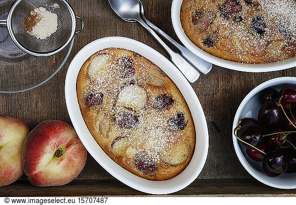 Bowls of gluten free homemade clafoutis with cherries  peaches and almonds