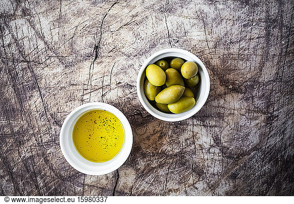 Bowls of olive oil and fresh olives