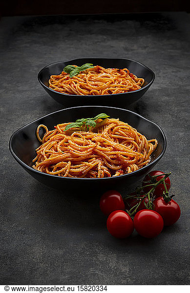 Bowls of spaghetti with basil and Parmesan