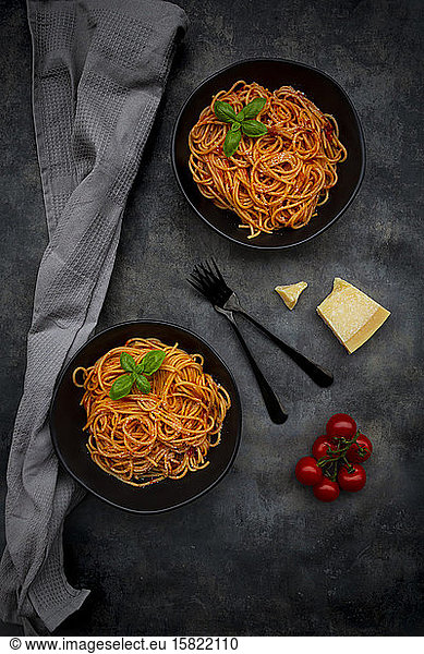 Bowls of spaghetti with basil and Parmesan