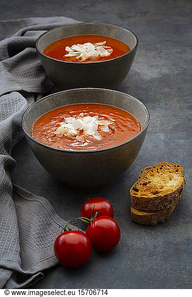 Bowls of vegan tomato soup with coconut flakes