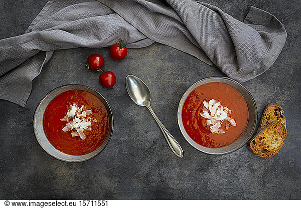 Bowls of vegan tomato soup with coconut flakes