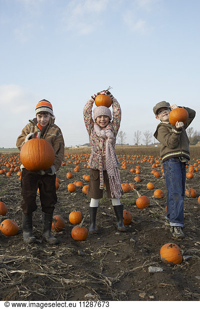 Boy and Girl in Pumpkin Patch