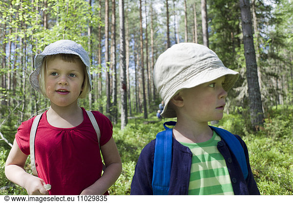 Boy and girl walking in forest