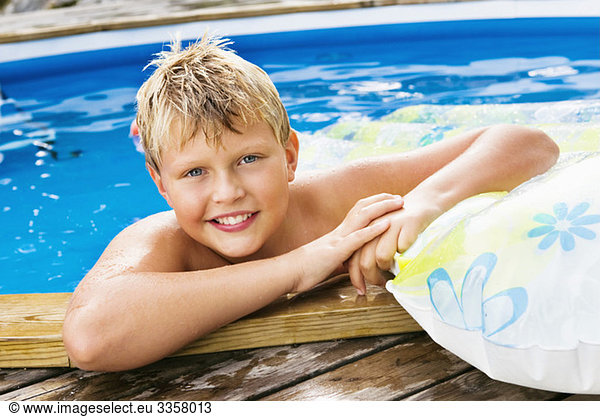 Boy bathing in outdoor pool