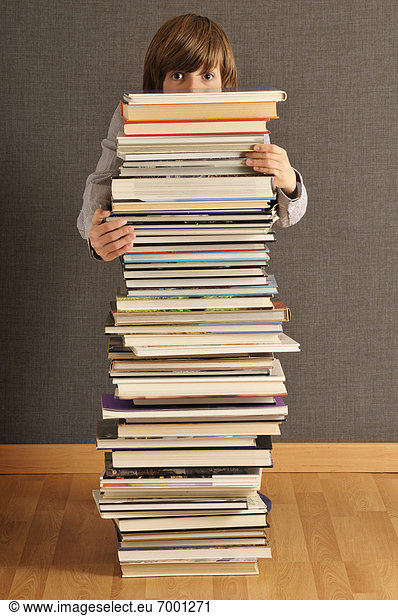 Boy Behind Stack of Books
