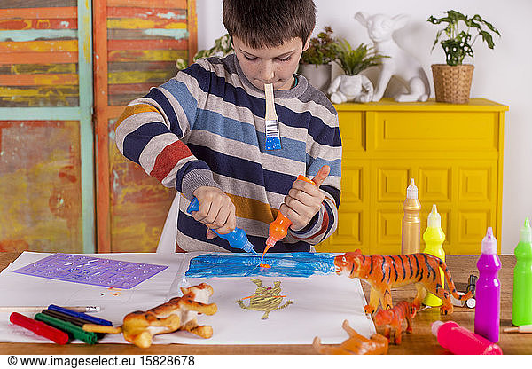 Boy creating artwork at home.