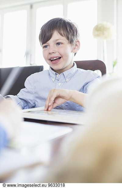 Boy doing his homework  smiling