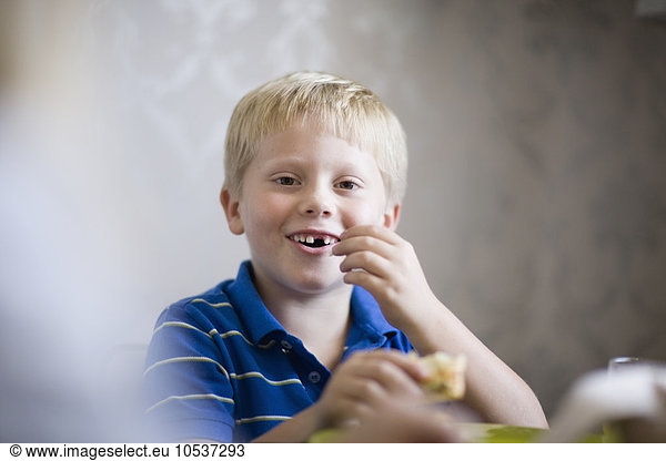 Boy eating at dinner table