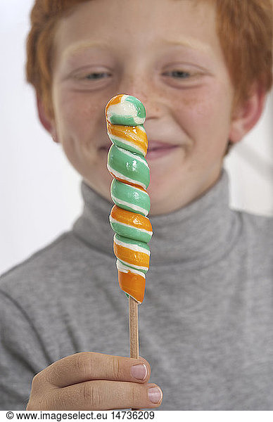 Boy eating lollipop.