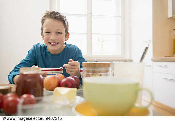 Boy having breakfast in kitchen