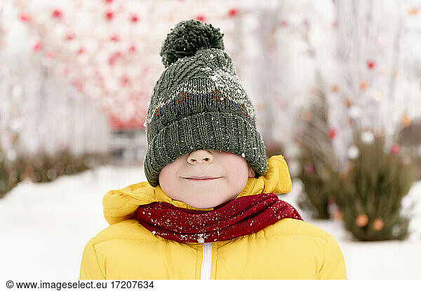 Boy hiding his face with knit hat