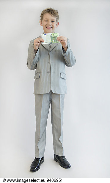 Boy holding hundred Euro in his hand  smiling  portrait