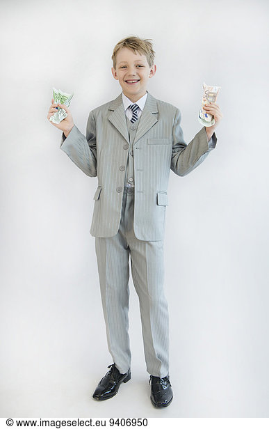 Boy holding paper money in his hand  smiling  portrait