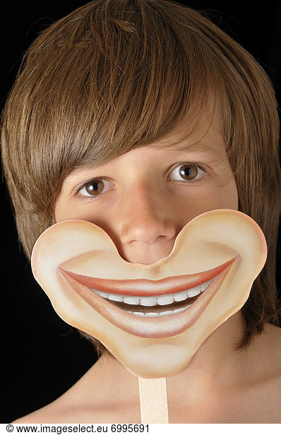 Boy Holding Smiling Mask