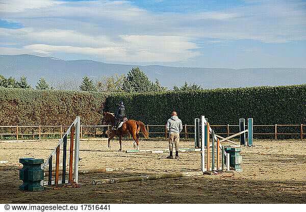 Boy horse riding at ranch.
