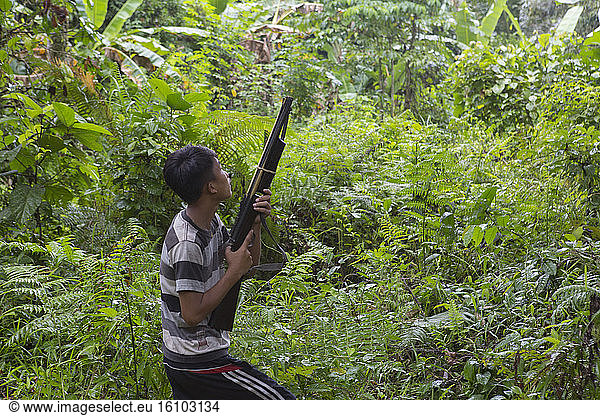 Boy hunting with a rifle  Pulau Siberut  Sumatra  Indonesia