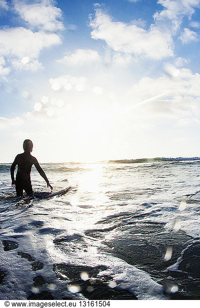 Boy in sea with surfboard  Encinitas  California  USA