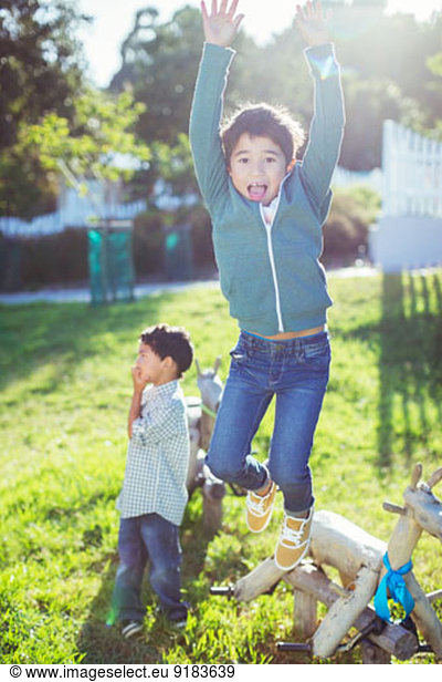 Boy jumping for joy outdoors