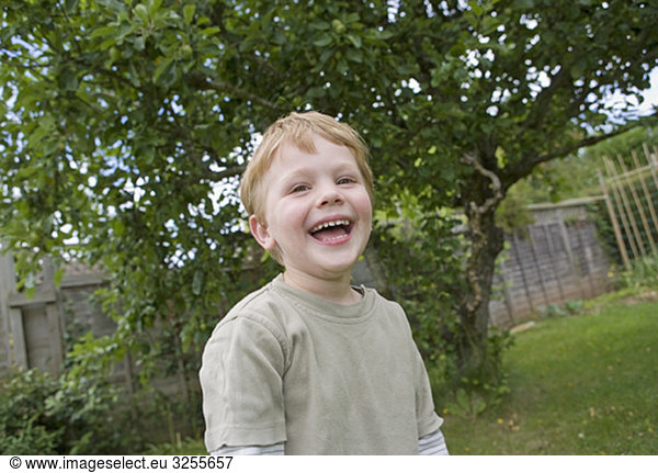 boy laughing in garden