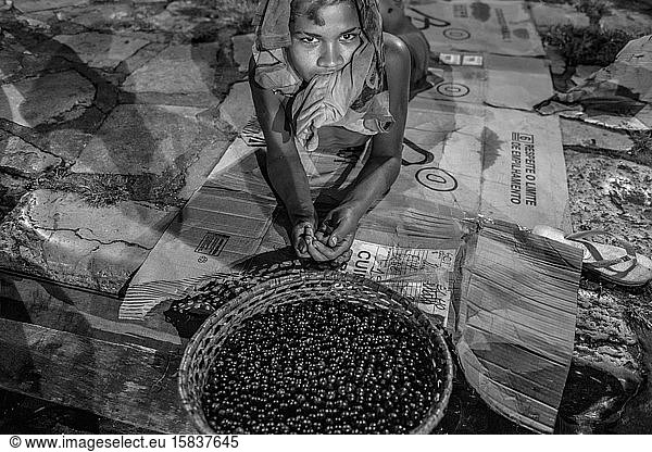 Boy laying on the streets selling acai berries