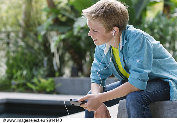 Boy listening to music on smartphone