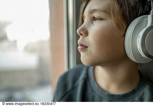 Boy listening to music through wireless headphones