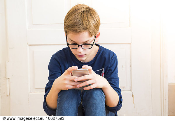 Boy looking at his smartphone