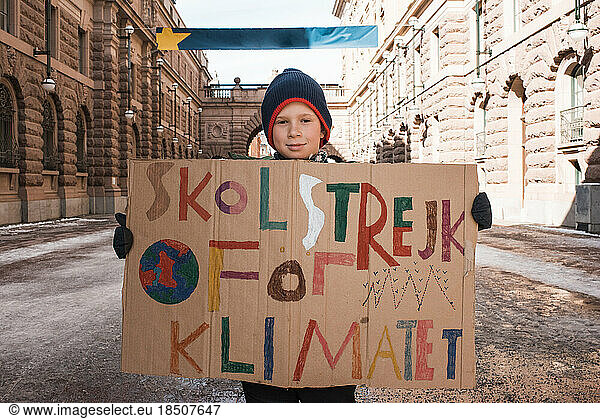 boy outside of Parliament House  Stockholm striking for climate change