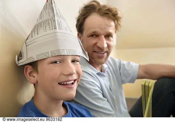 Boy paper hat father smiling bonding fun