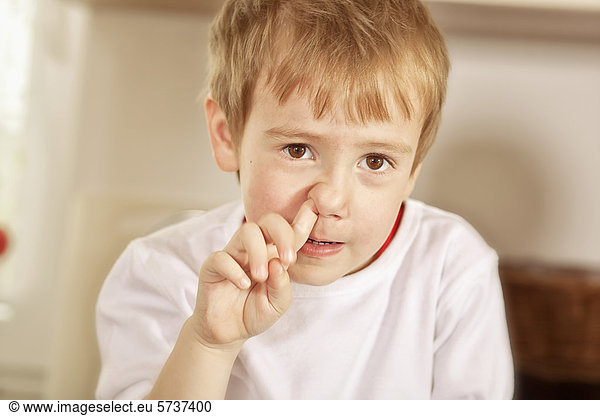 Boy picking his nose