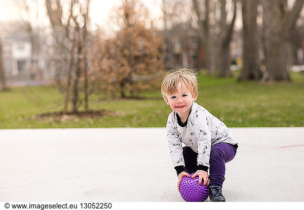 Boy playing ball in park