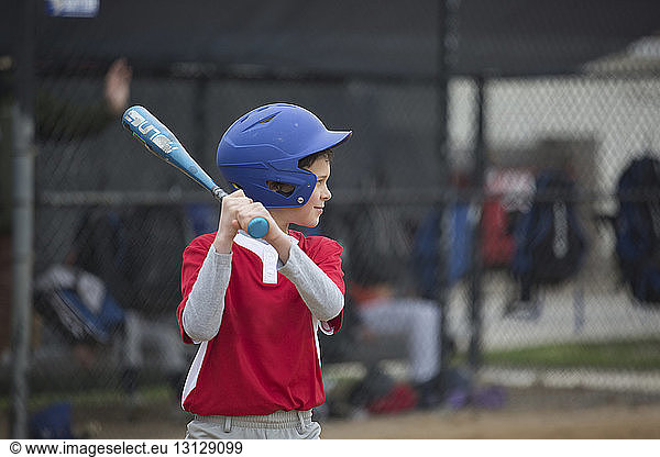 Boy playing baseball at sports field